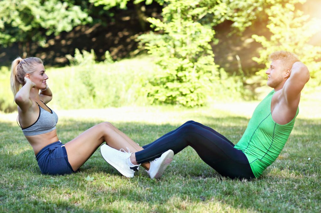 Young couple working out in park